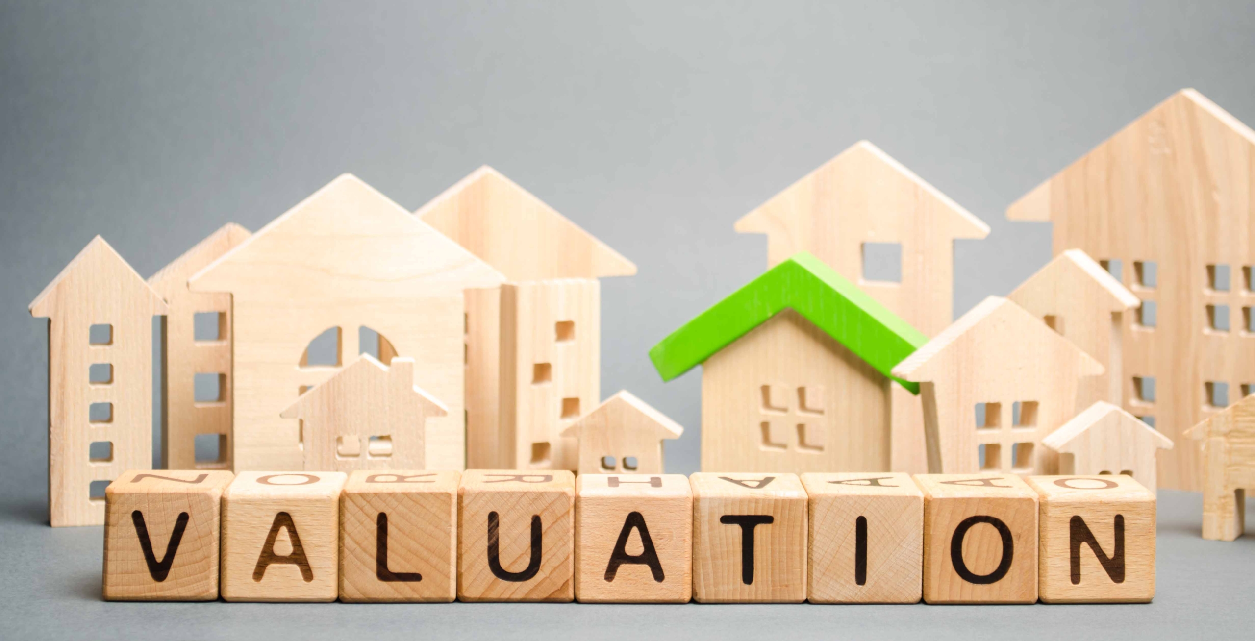 picture of wooden houses and bricks with the word valuation written on them